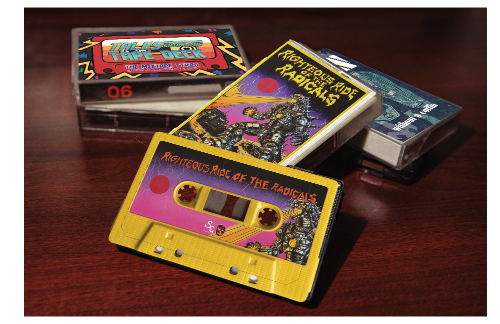 Colorful cassette tapes with graphic designs on a wooden surface